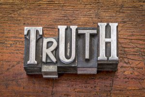 truth word in mixed vintage metal type printing blocks over grunge wood