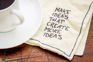 Make ideas advice that create new ideas - handwritten advice on a cocktail napkin with a cup of coffee
