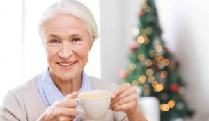 happy senior woman with cup of coffee at home